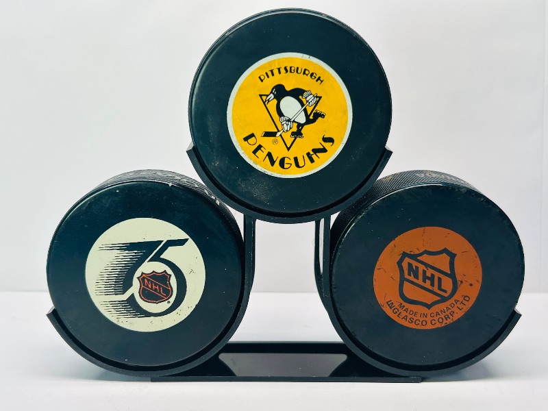 Photo 1 of 594609…3 used hockey pucks on display stand - some wear and scuffs