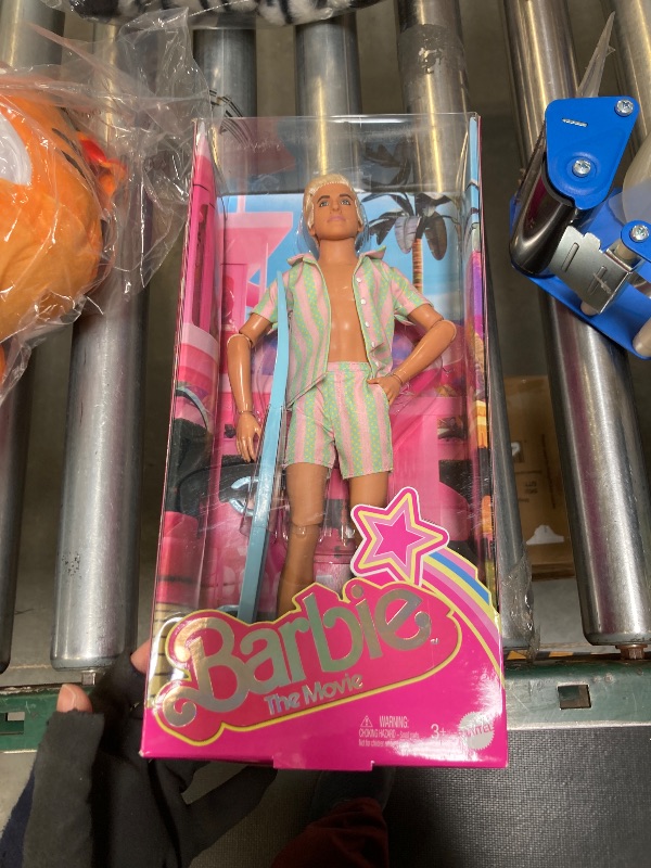 Photo 1 of Barbie The Movie Ken Doll Wearing Pastel Pink and Green Striped Beach Matching Set with Surfboard and White Sneakers