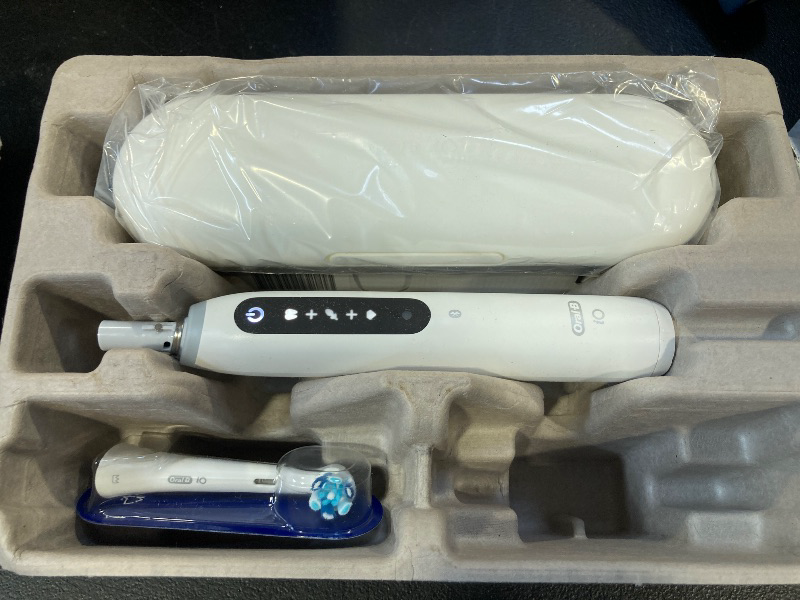 Photo 1 of Oral-B iO Series 5 Rechargeable Electric Toothbrush with Visible Pressure Sensor to Protect Gums, 2 Minute Timer, 5 Cleaning Settings, 1 Replacement Toothbrush Heads, and Travel Case, White