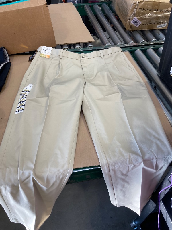 Photo 1 of Haggar Men's Iron Free Premium Khaki Classic Fit Pleat Front Expandable Waist Casual Pant (Regular and Big & Tall Sizes), Sand, 38W x 29L