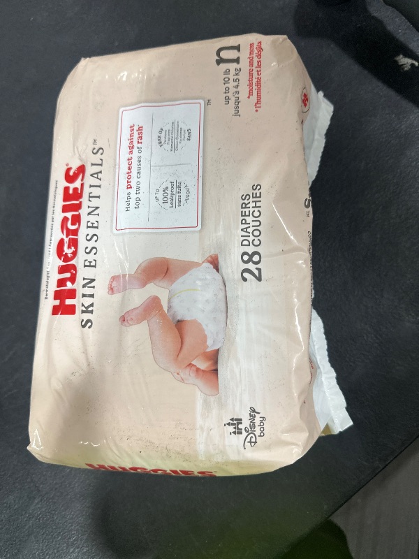 Photo 1 of Huggies Size Newborn Diapers, Skin Essentials Baby Diapers, Size Newborn (6-9 lbs), 28 Count, Packaging May Vary