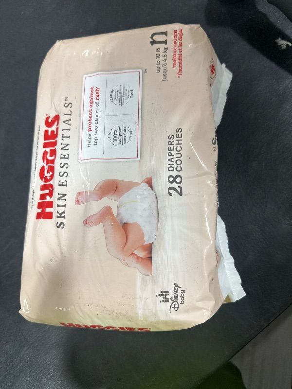 Photo 1 of Huggies Size Newborn Diapers, Skin Essentials Baby Diapers, Size Newborn (6-9 lbs), 28 Count, Packaging May Vary