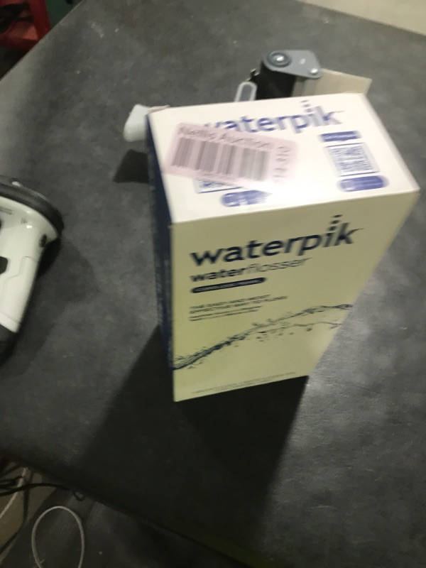 Photo 1 of Waterpik Cordless Pearl Rechargeable Portable Water Flosser for Teeth, Gums, Braces Care and Travel with 4 Flossing Tips - ADA Accepted, WF-13 White, Packaging May Vary