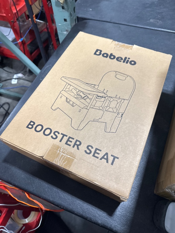 Photo 1 of BABELIO Portable Booster Seat for Kitchen Chair with PU Waterproof Cushion, Compact Folding High Baby Chair for Travel with Feeding Tray, Great for Baby, Dining Table, Camping, Beach, Slate Grey