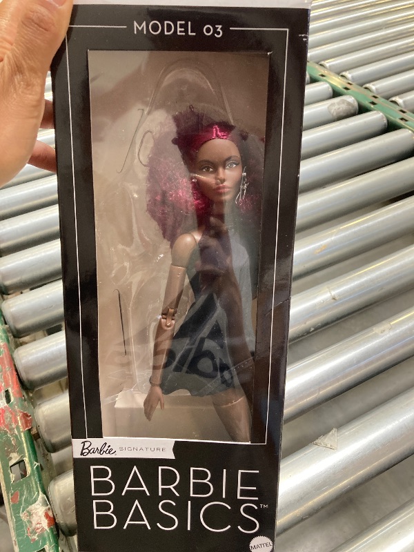 Photo 1 of Barbie Basics Model 03 Collector Doll with Red Curly Hair, Black Mini Dress & Boots, Universal-fit Fashions, Posable Tall Body & Swappable Doll Head