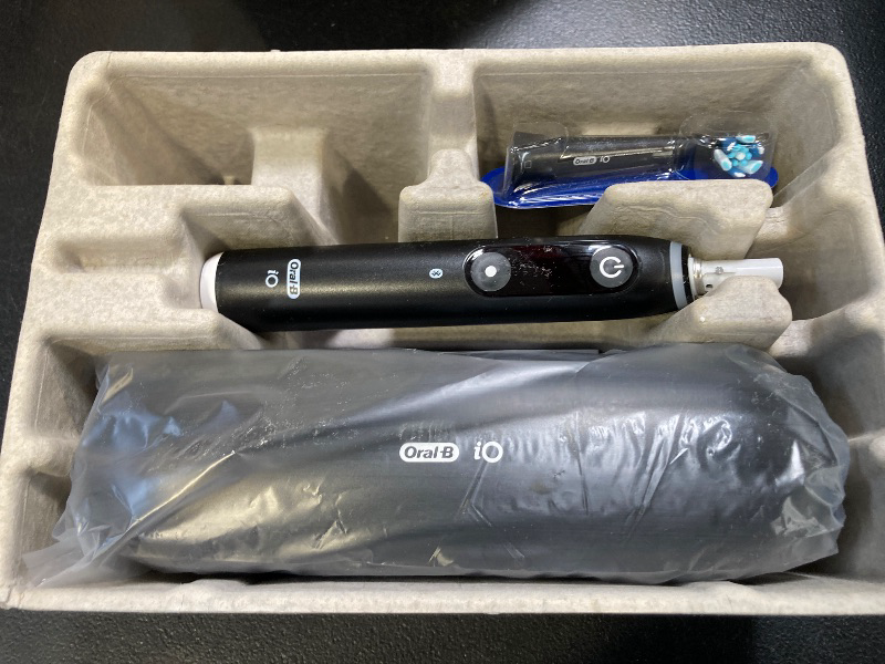 Photo 1 of Oral-B iO Series 10 Rechargeable Electric Toothbrush with Visible Pressure Sensor to Protect Gums, 2 Min Timer, 7 Cleaning Settings, 4 Replacement Toothbrush Heads, and Charging Travel Case, Black