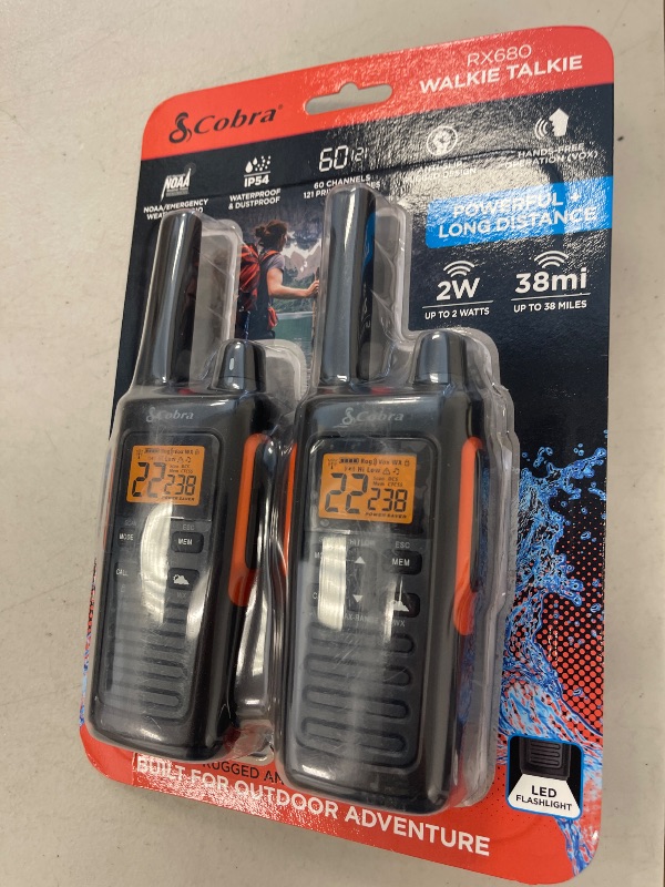 Photo 1 of Cobra RX680 Walkie Talkies (2-Pack) - Rugged & Splashproof Two Way Radios Long Range, IP54 Water Resistant Design, 60 Pre-Programmed Channels, Weather Alerts, Included Charging Dock (Black/Orange)