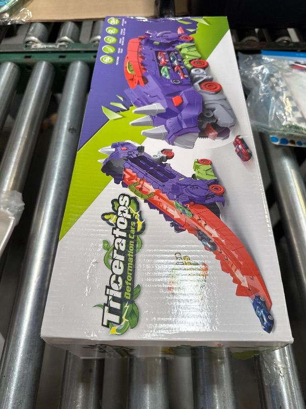 Photo 1 of FINcredible Dinosaur Transport Truck with 6 Racing Cars - Car Transporter Dinosaur Truck with Foldable Sliding Ramp - Dino Birthday Gift Toys for 3 4 5+ Year Old Boy - Toddler & Kids (Purple)