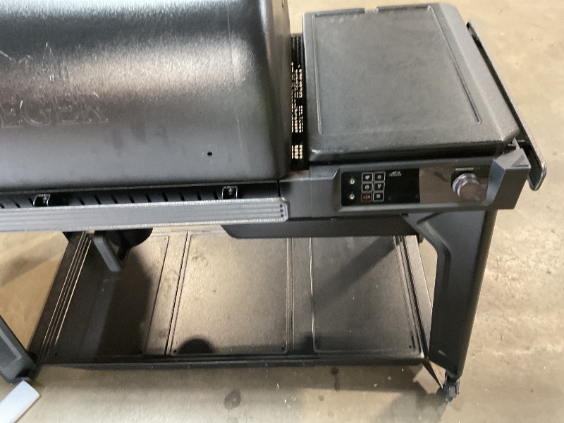 Photo 1 of ** some parts need assembly. Missing hardware for wheels. Brake on one of the wheels is broken.**Traeger Woodridge Pro Wood Pellet Grill & Smoker