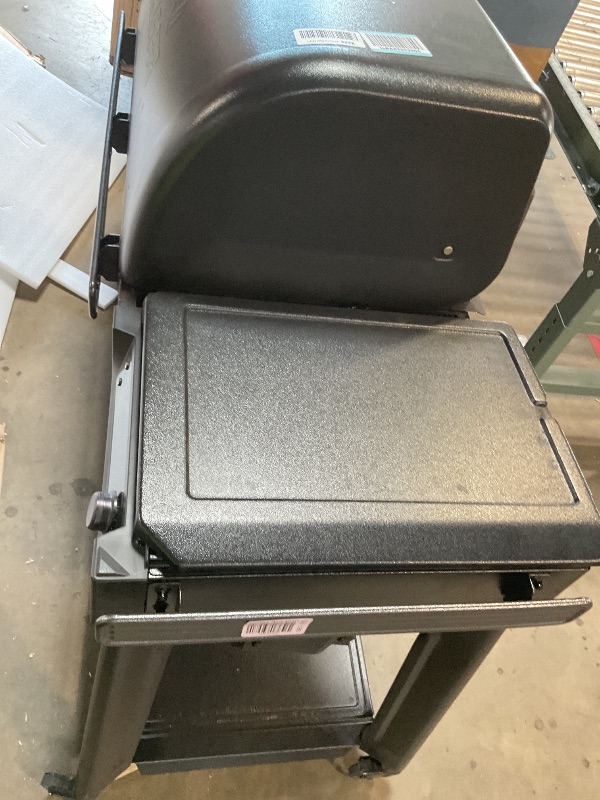 Photo 1 of ** some parts need assembly. Missing hardware for wheels. Brake on one of the wheels is broken.**Traeger Woodridge Pro Wood Pellet Grill & Smoker