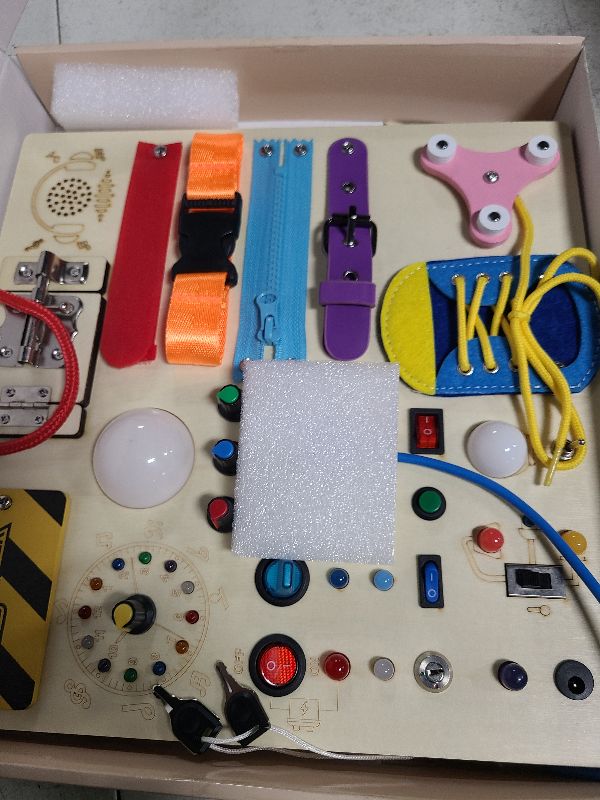 Photo 1 of 23 in 1 Busy Board Montessori Toys for 1-3 Year Old Wooden Learning Educational Toy for Toddlers with 15 Switches, 26 LED Lights, Music Boxes, Locks,Zippers Toddler Sensory Toys for Soothing A Baby