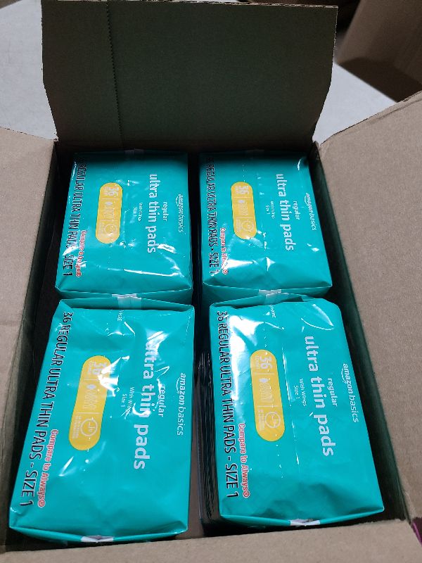 Photo 1 of Amazon Basics Regular Absorbency Pads for Women, Ultra Thin with Flexi-Wings, Unscented, Size 1, 144 Count, (4 Packs of 36) (Previously Solimo)