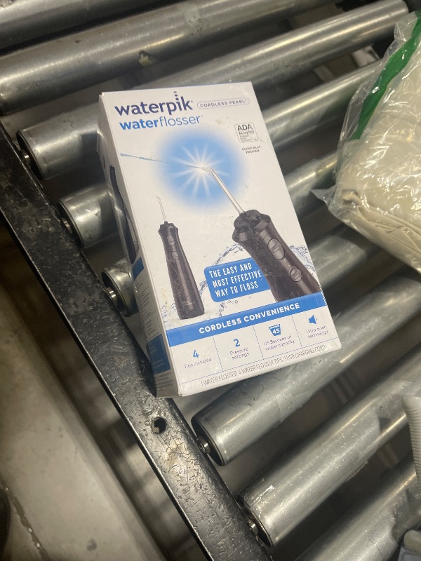 Photo 1 of Waterpik Cordless Pearl Rechargeable Portable Water Flosser for Teeth, Gums, Braces Care and Travel with 4 Flossing Tips - ADA Accepted, WF-13 Black, Packaging May Vary