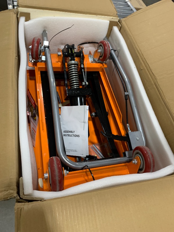 Photo 1 of VEVOR Hydraulic Lift Table Cart, 330lbs Load Capacity 50 Inch Lifting Height, Manual Single Scissor Lift Table with Non-Slip Pad and 4 Wheels, Hydraulic Scissor Cart for Material Handling, Orange
