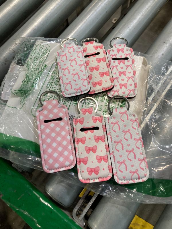 Photo 1 of ****ONLY 6 KEYCHAIN****Yeyeplum 12 Pcs Lipstick Holder Keychain Bulk Cute Pocket Lip Balm Holder Keychain Backpack Purse Accessories for Women Lip Gloss Sleeve Pouch, 6 Style(Pink Bow)