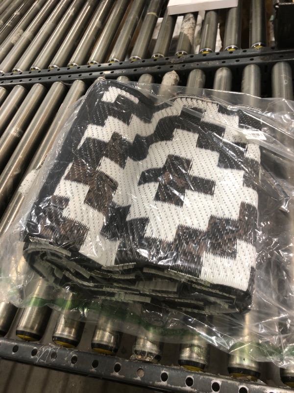 Photo 1 of Outdoor Patio Plastic Straw Rug - 5x8 ft Outdoor Camping Rug Waterproof Reversible, Area Carpet Patios Clearance RV, Outside Porch Balcony Deck for Camper, Black & White