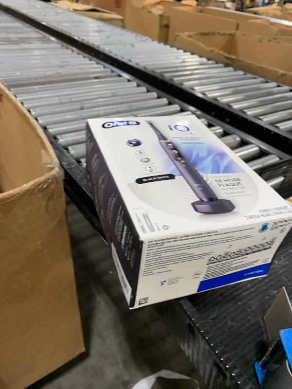Photo 1 of Oral-B iO Deep Clean + Protect Rechargeable Electric Toothbrush, Black with a iO Series 7 Toothbrush, 2 Replacement Brush Heads, and a Charging Travel Case