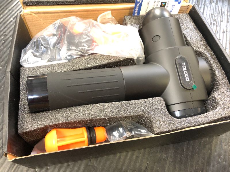 Photo 1 of The image shows a TOLOCO Percussion Massage Gun, model EM26. 
