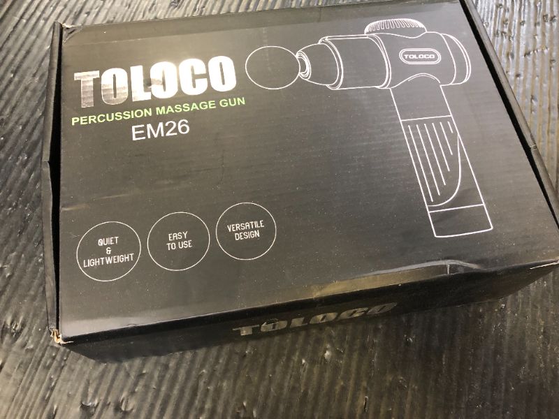 Photo 1 of The image shows a TOLOCO Percussion Massage Gun, model EM26. 
