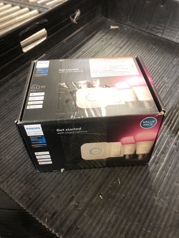 Photo 1 of Philips Hue Smart Light Starter Kit - Includes (1) Bridge, (1) Dimmer Switch and (2) A19 LED Bulbs - White and Color Ambiance Color-Changing Light - 800LM - E26 - Control with App or Voice Assistant