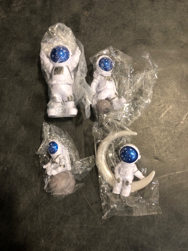 Photo 1 of Ni-JASW Blue White Astronaut Statues Set of 4, Spaceman Sculpture Figurines Outer Space Theme Decor for Nursery Room Cake Topper