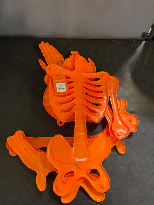 Photo 1 of Hyde & Eek! Halloween 59" Poseable Orange Skeleton Indoor/Outdoor Decoration