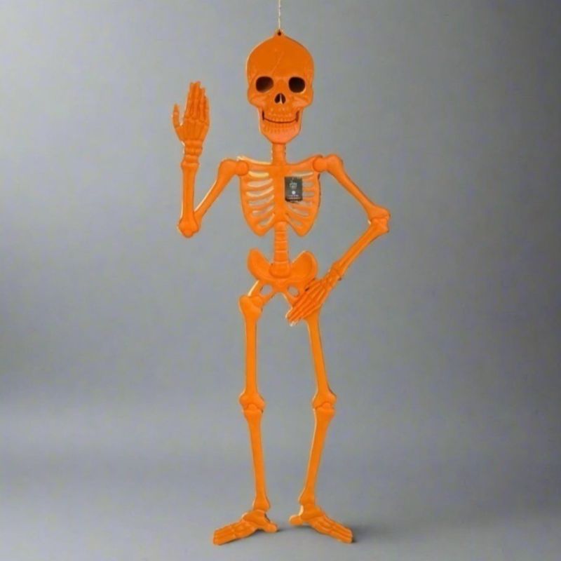 Photo 1 of Hyde & Eek! Halloween 59" Poseable Orange Skeleton Indoor/Outdoor Decoration