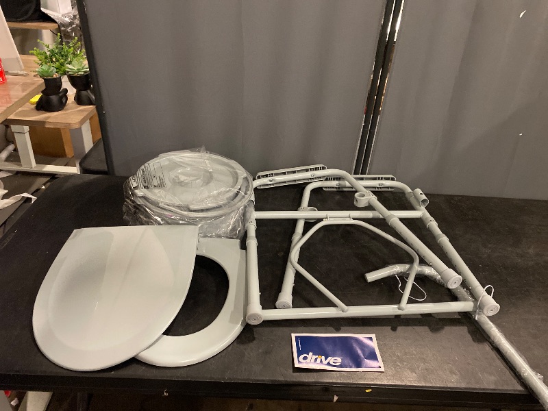 Photo 1 of Drive Medical 11148-1 Folding Steel Bedside Commode Chair, Portable Toilet, Supports Individuals Weighing Up To 350 Lbs, with 7.5 Qt. Bucket and 13.5 Inch Seat, Grey