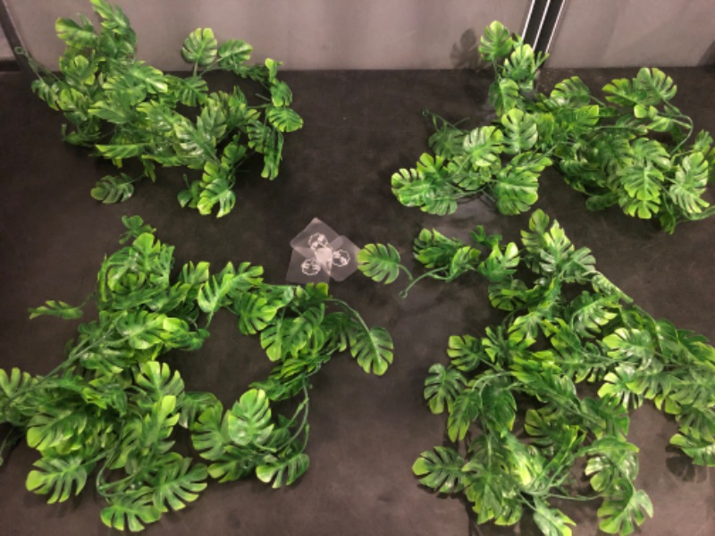 Photo 1 of Artificial Hanging Plants 4 Pack, Fake Hanging Monstera Leaves Ivy Vine Faux Greenery Tropical Palm Leaves Outdoor Hanging Plants UV Resistant Jungle Leaf Plant
