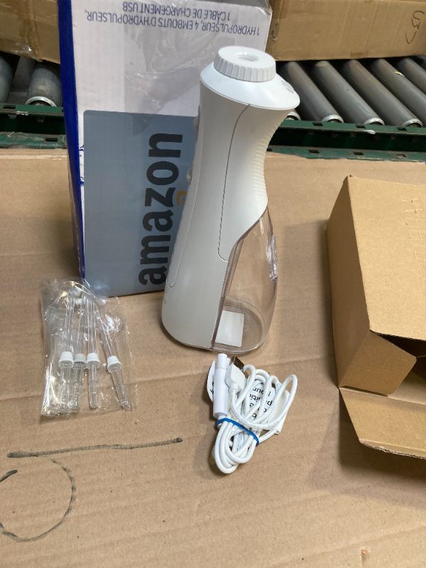 Photo 1 of Waterpik Cordless Pearl Rechargeable Portable Water Flosser for Teeth, Gums, Braces Care and Travel with 4 Flossing Tips - ADA Accepted, WF-13 White, Packaging May Vary