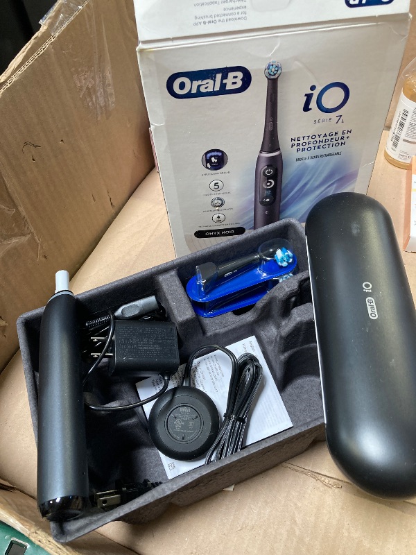 Photo 1 of Oral-B iO Deep Clean + Protect Rechargeable Electric Toothbrush, Black with a iO Series 7 Toothbrush, 2 Replacement Brush Heads, and a Charging Travel Case