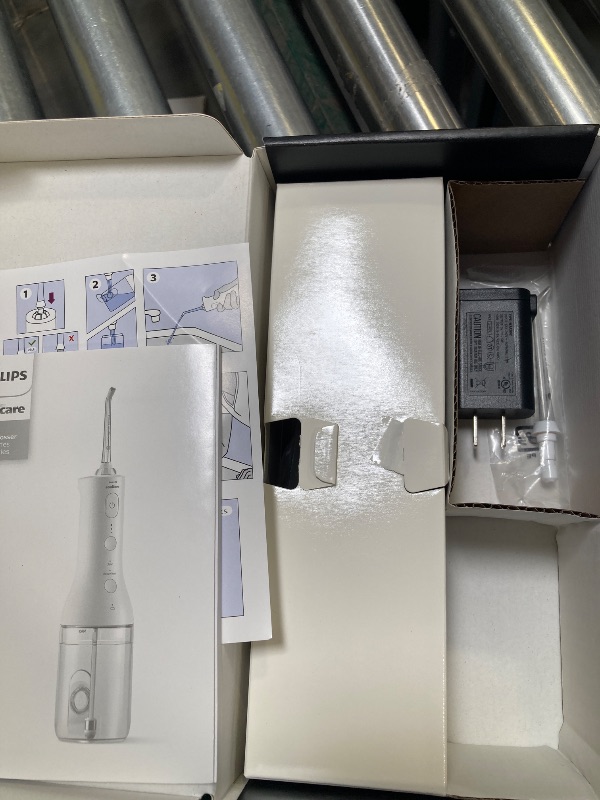 Photo 1 of Philips Sonicare Cordless Power Flosser 3000, Water Flosser with Innovative Quad Stream Technology, Oral Irrigator with 2 Flossing Modes and 3 Intensity Levels, Ergonomic Design, Black, HX3826/23