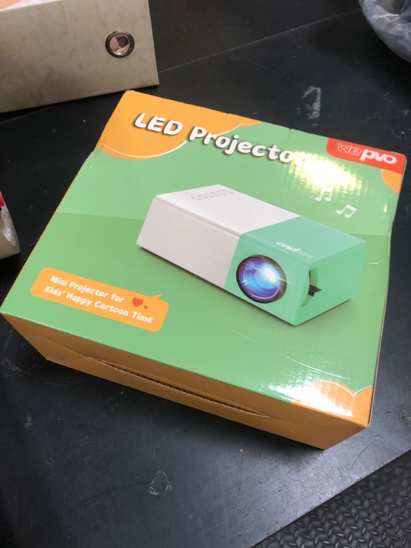 Photo 1 of wepvo Projector Mini Portable Outdoor Movie Projectors, LED Pico Video Projector for Home Theater Film Projectors, Compatible with Smartphone/ Tablet/ Laptop/ TV Stick/ PS/ USB