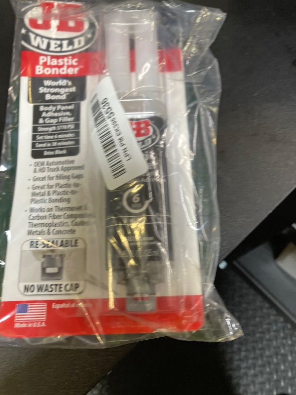 Photo 1 of J-B Weld 50139 Plastic Bonder Body Panel Adhesive and Gap Filler Syringe - Black - 25 ml