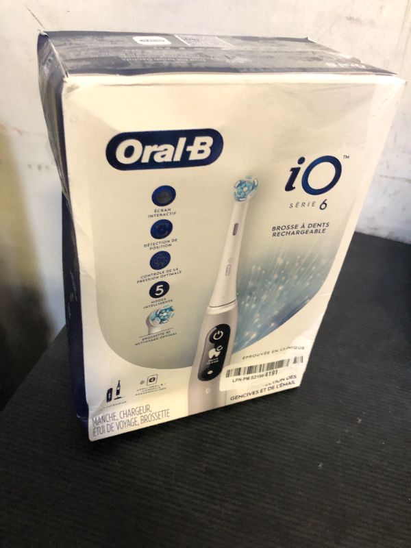 Photo 1 of Oral-B iO Series 6 Rechargeable Electric Toothbrush with Visible Pressure Sensor to Protect Gums, 2 Minute Timer, 5 Cleaning Settings, 1 Replacement Toothbrush Head, and Travel Case, Grey Opal