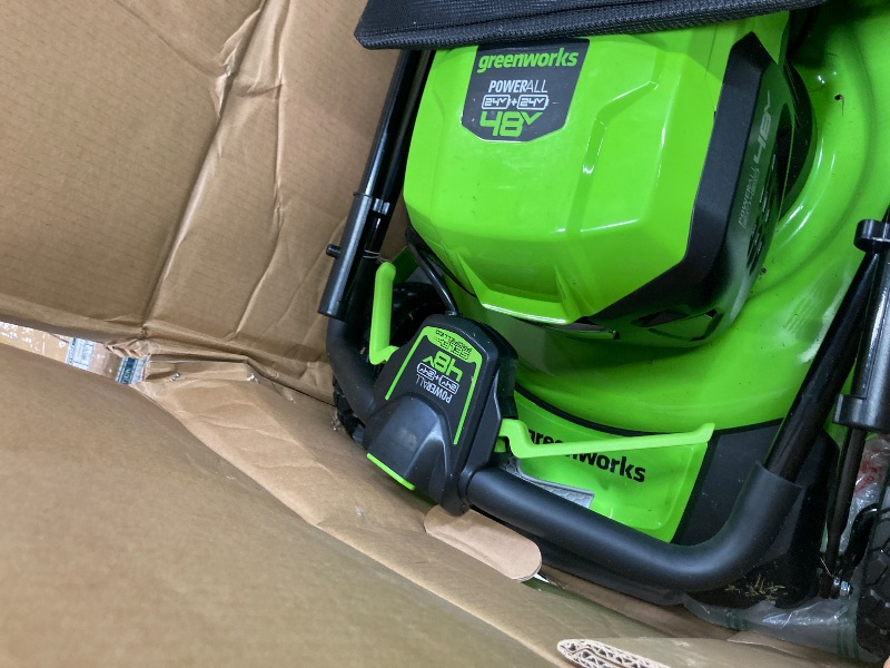 Photo 1 of ***(SELLING AS IS -MISSING PIECES )*** Greenworks 48V (2x24V) 21" Brushless Mower+12" String Trimmer+320CFM Blower,(2) 5.0Ah Batteries and 4A Dual Port Charger  ***(SOME SCUFFS/SCRATCHES, DIRT/GRASS RESIDUE, MISSING PIECES BOX RIPPED/TORN)***