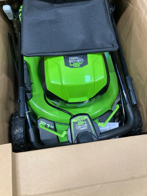 Photo 1 of ***(SELLING AS IS -MISSING PIECES )*** Greenworks 48V (2x24V) 21" Brushless Mower+12" String Trimmer+320CFM Blower,(2) 5.0Ah Batteries and 4A Dual Port Charger  ***(SOME SCUFFS/SCRATCHES, DIRT/GRASS RESIDUE, MISSING PIECES BOX RIPPED/TORN)***
