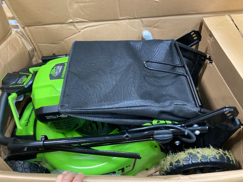 Photo 1 of ***(SELLING AS IS -MISSING PIECES )*** Greenworks 48V (2x24V) 21" Brushless Mower+12" String Trimmer+320CFM Blower,(2) 5.0Ah Batteries and 4A Dual Port Charger  ***(SOME SCUFFS/SCRATCHES, DIRT/GRASS RESIDUE, MISSING PIECES BOX RIPPED/TORN)***