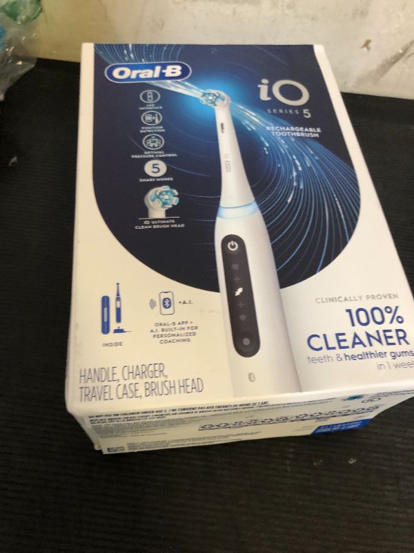 Photo 1 of Oral-B iO Series 5 Rechargeable Electric Toothbrush with Visible Pressure Sensor to Protect Gums, 2 Minute Timer, 5 Cleaning Settings, 1 Replacement Toothbrush Heads, and Travel Case, White