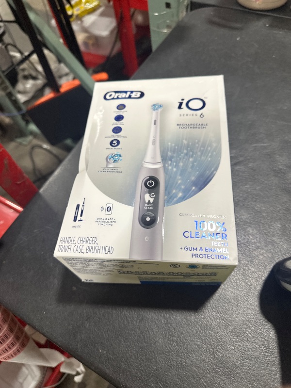 Photo 1 of Oral-B iO Series 6 Rechargeable Electric Toothbrush with Visible Pressure Sensor to Protect Gums, 2 Minute Timer, 5 Cleaning Settings, 1 Replacement Toothbrush Head, and Travel Case, Grey Opal