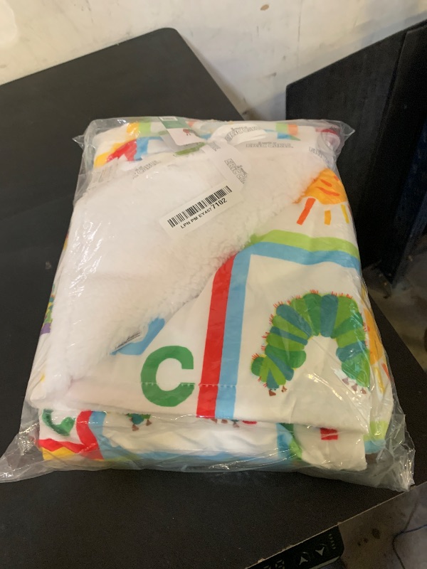 Photo 1 of The Very Hungry Caterpillar Snuggle Blanket with Rattle and Crinkle, Green with Colorful Dot, 10 inch Square