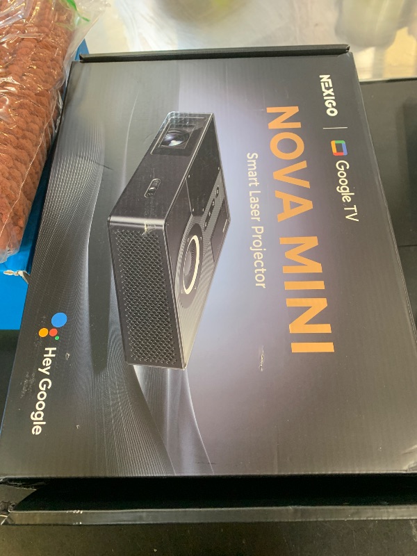 Photo 1 of NexiGo Nova Mini, Portable Laser Projector, Google TV w/Netflix, 1080p FHD, 1200 Lumens, 15000:1 Contrast w/SAE, 3D, Auto Setup, 150" Display, 8W Dolby Audio, Portable for Home & Outdoor (Renewed)