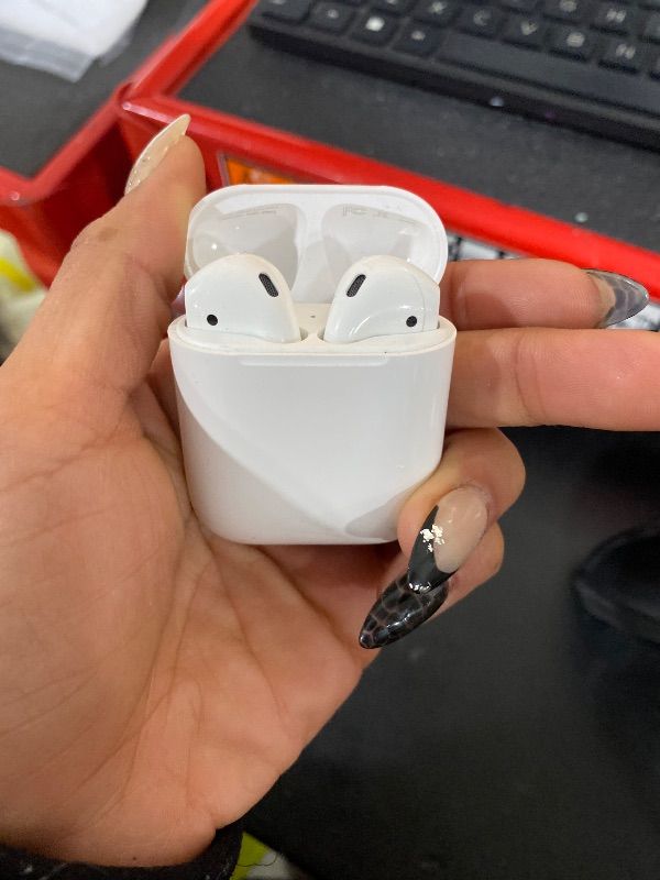 Photo 1 of Apple AirPods Wireless Ear Buds, Bluetooth Headphones with Lightning Charging Case Included, Over 24 Hours of Battery Life, Effortless Setup for iPhone