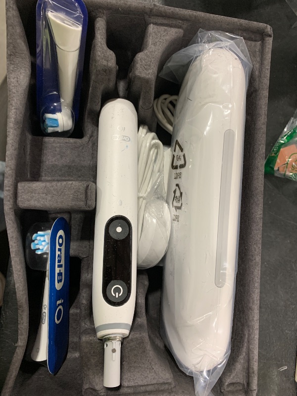Photo 1 of Oral-B iO Deep Clean + Protect Rechargeable Electric Toothbrush, White with a iO Series 7 Toothbrush, 2 Replacement Brush Heads, and a Charging Travel Case