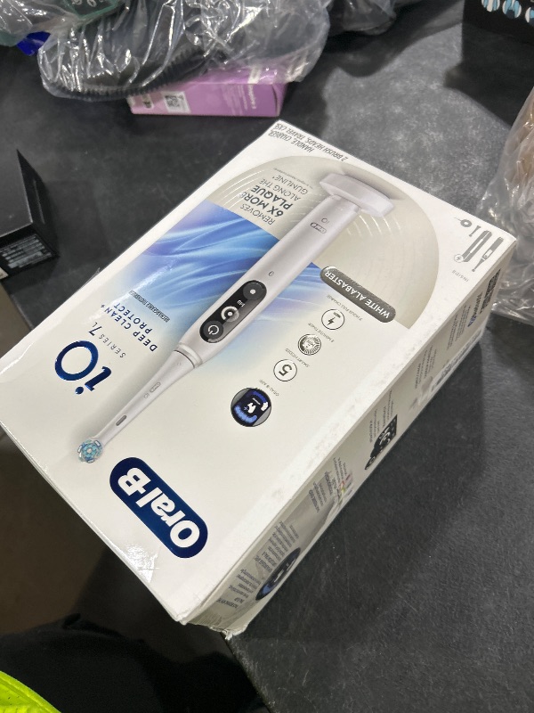 Photo 1 of Oral-B iO Deep Clean + Protect Rechargeable Electric Toothbrush, White with a iO Series 7 Toothbrush, 2 Replacement Brush Heads, and a Charging Travel Case