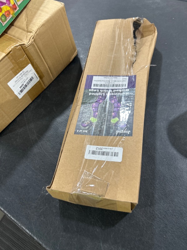 Photo 1 of Juegoal Set of 2 Halloween Lighted Wicked Purple Witch Legs with Stakes, 22" Light Up Tinsel Halloween Yard Sign Prop Timer & 8 Modes, Battery Operated for Outdoor Party Haunted House Garden Decor