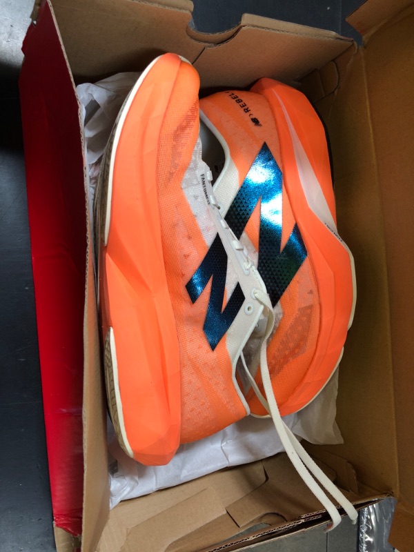 Photo 1 of New Balance Men's FuelCell Rebel V4 Running Shoe, Hot Mango/Angora/Black, 8.5