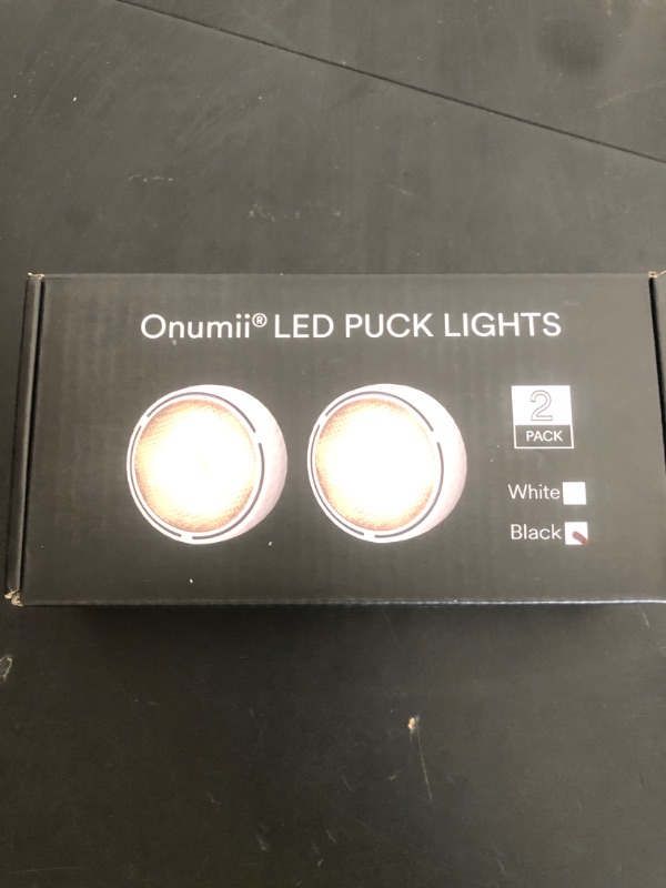 Photo 1 of Battery Operated Puck Lights with Remote LED Under Cabinet Lighting Wireless Stick on Lights Color Changing Timer Tap Lights for Cabinets Shelves Closets Display Case - 2Pack Black