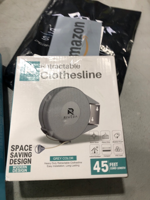 Photo 1 of Retractable Clothesline - Portable Heavy Duty Indoor and Outdoor Washing Line - 45 Feet PVC Retracting Clothes Line with Wall Mount Hang The Wet Dry Clothing Laundry - Easy Installation (Grey)