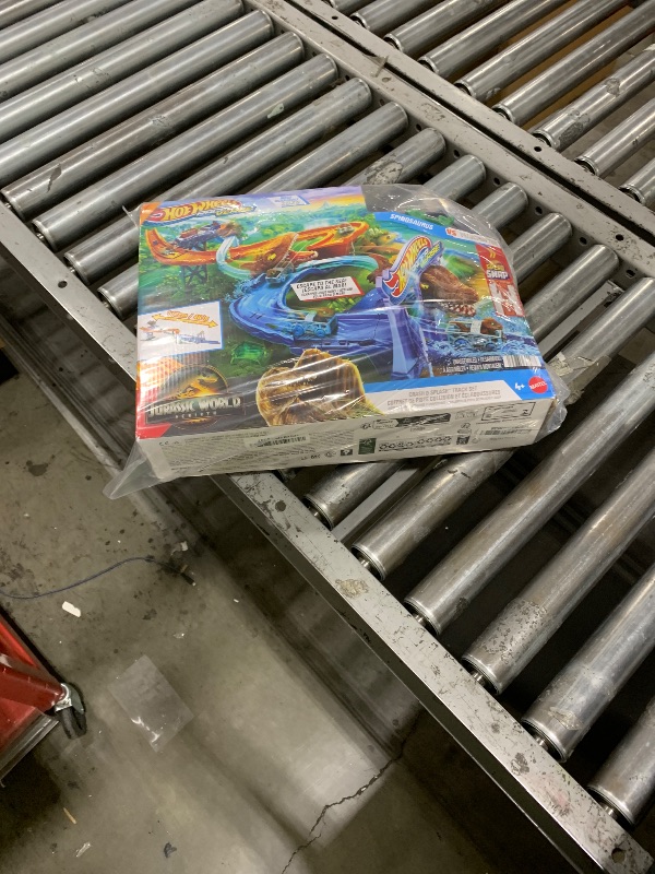 Photo 1 of Hot Wheels Toy Car Track Set, RacerVerse Jurassic World Crash & Splash Playset with Die-Cast Velociraptor Vehicle, Dinosaur Race with Spinosaurus